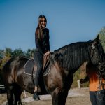 Older woman on horseback in Bulgaria, riding in the mountains, hiking.